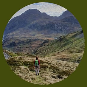 Woman walking into the mountains